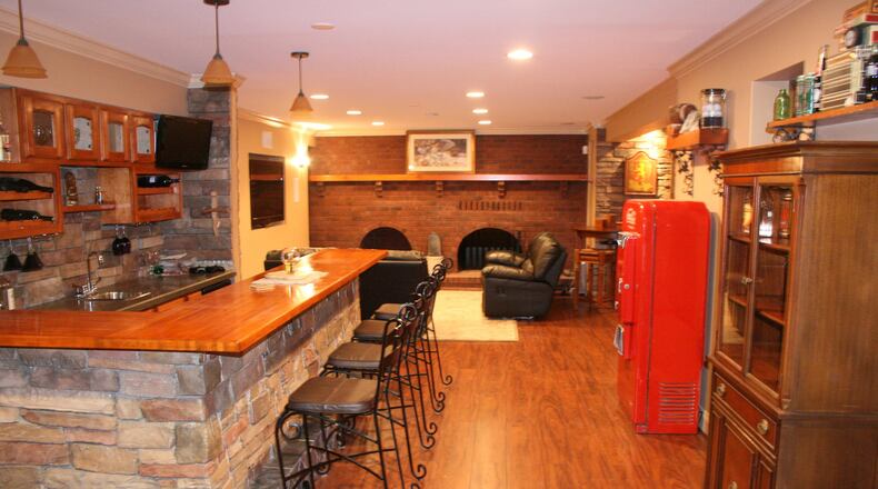 A lower level bar and game table creates a warm and inviting space. (Handout/TNS)