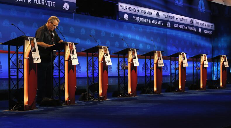 A crew member checks the candidate podiums at the venue for the Oct. 28 CNBC Republican presidential debate, Tuesday, Oct. 27, 2015, inside the Coors Events Center at the University of Colorado in Boulder, Colo. (AP Photo/Brennan Linsley)