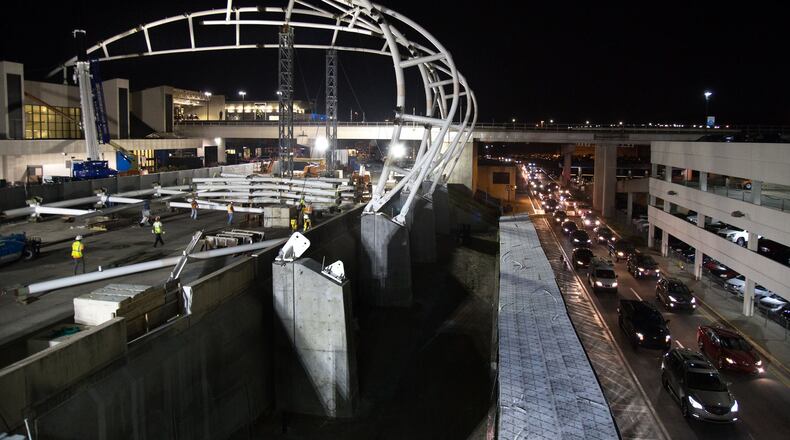 Airport traffic at the north terminal is backed up Wednesday night during the construction of a canopy that will cover the terminal roadway and curbside areas. STEVE SCHAEFER / SPECIAL TO THE AJC
