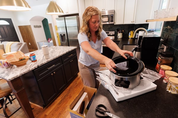 Gross sets out a crockpot in preparation for World Cup guests on Thursday, June 11, 2026. (Estela Muñoz/AJC)