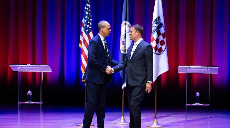 Democrat Jay Jones, left, and Republican incumbent Jason Miyares shake hands at the start of the Virginia attorney general debate in Richmond, Va., Thursday, Oct. 16, 2025. (Mike Kropf/Richmond Times-Dispatch via AP, Pool)