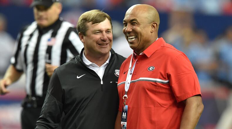090316 Atlanta: Georgia Bulldogs head coach Kirby Smart  jokess with former Bulldog and NFL star Hines Ward before taking on the North Carolina Tar Heels in the Chick-fil-A Kickoff Game at the Georgia Dome Saturday September 3, 2016. BRANT SANDERLIN/BSANDERLIN@AJC.COM