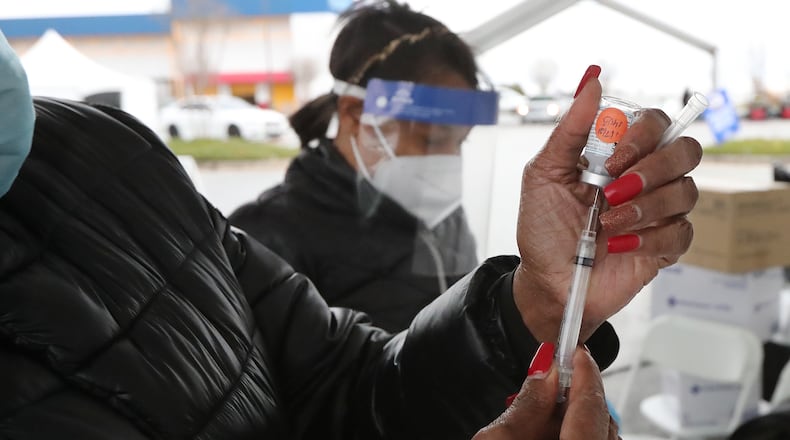 DORAVILLE: RN Wanda Kelley prepares a Moderna COVID-19 vaccine for a health care worker at the DeKalb COVID-19 BrandsMart USA drive through testing site on Thursday, Jan. 7, 2021, in Doraville.   Curtis Compton / Curtis.Compton@ajc.com”
