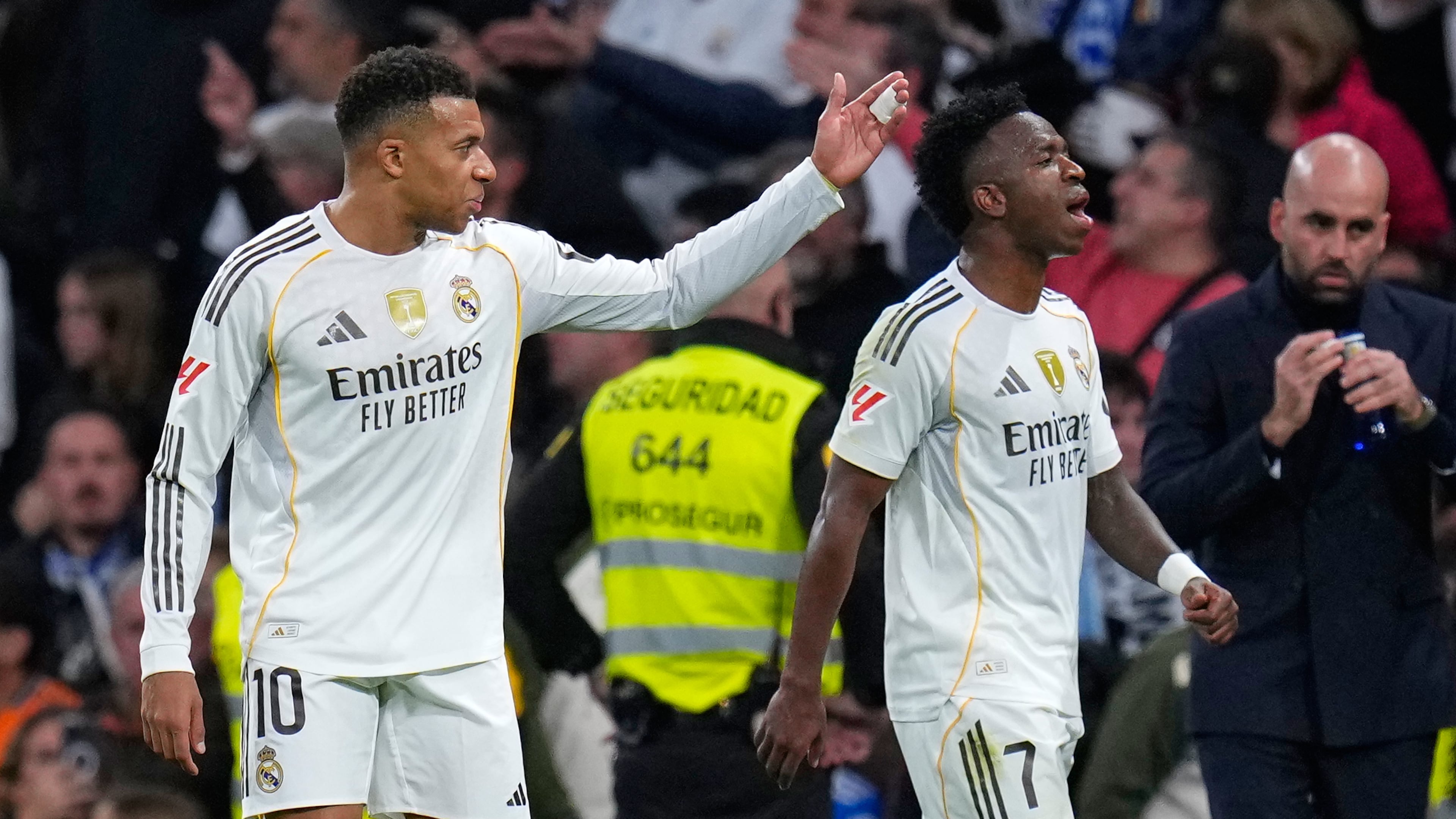 Real Madrid's Kylian Mbappe, left, and Vinicius Junior react during the Spanish La Liga soccer match between Real Madrid and Celta Vigo in Madrid, Spain, Sunday, Dec. 7, 2025. (AP Photo/Manu Fernandez)