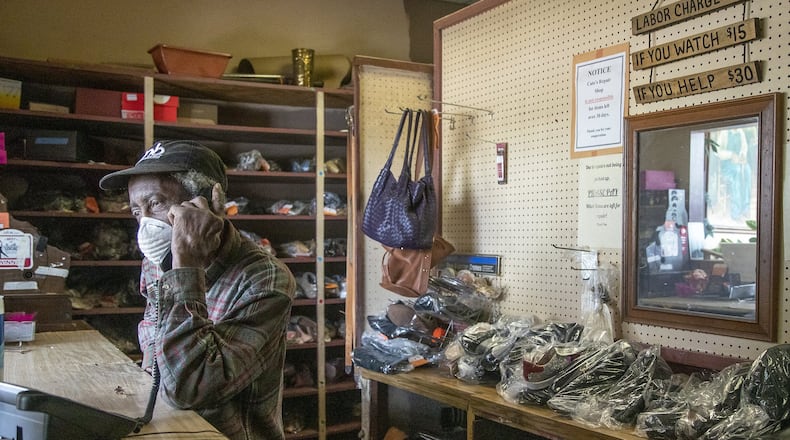 Joe Jordan, 82, owner of Cato Shoe Repair, answers a phone call from a customer inside his store in Atlanta. He and his wife, Hattie, have been repairing shoes since the 1960s. In addition to shoes, they work on belts, purses, luggage and more. (ALYSSA POINTER / ALYSSA.POINTER@AJC.COM)