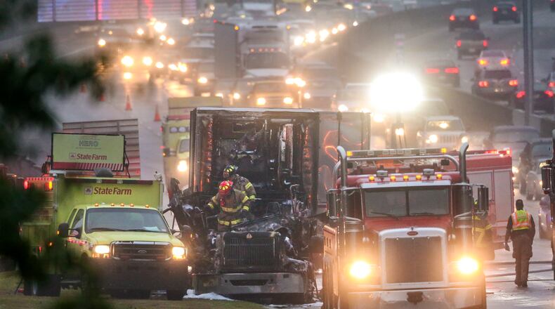 DeKalb County Firefighters emerge from the cab of a burned out truck Thursday morning, Nov. 5, 2015 after putting out a fire that erupted during the early morning commute.
