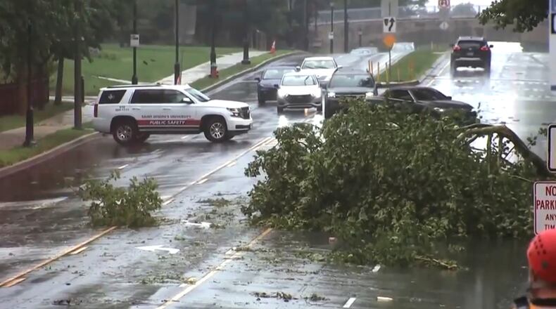 This image taken from video shows a broken tree branch on a street, Sunday, July 12, 2026 after a line of severe, short thunderstorms passed through the city the day before in Philadelphia. (WPVI-TV/6ABC via AP)
