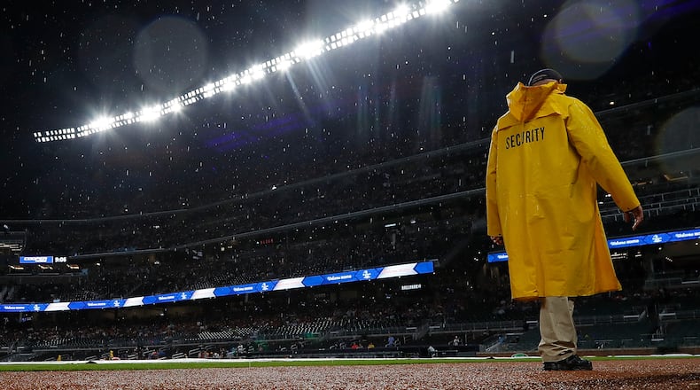 A member of the security team walks the infield during a rain delay prior to the Braves-Cubs game at SunTrust Park on Tuesday night. (Photo by Kevin C. Cox/Getty Images)