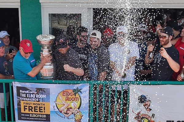 Members of the Florida Panthers hockey team celebrate with fans outside the Elbo Room, Wednesday, June 18, 2025, in Fort Lauderdale, Fla., the morning after defeating Edmonton in Game 6 of the Stanley Cup Final. (Amy Beth Bennett/South Florida Sun-Sentinel via AP)