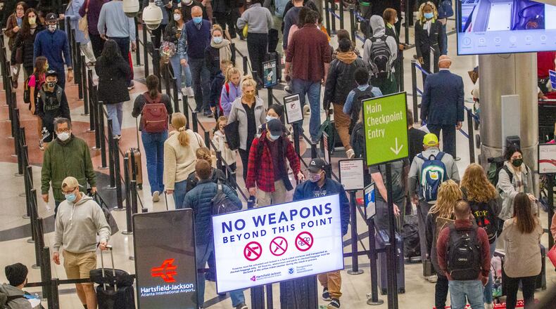 Travelers go through security at Hartsfield-Jackson Atlanta International Airport Sunday, November 21, 2021. STEVE SCHAEFER FOR THE ATLANTA JOURNAL-CONSTITUTION