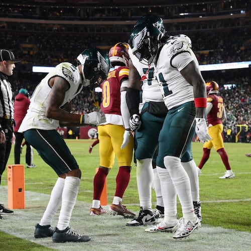 Philadelphia Eagles wide receiver Devonta Smith, front left, celebrates with teammates after his touchdown against the Washington Commanders during the first half of an NFL football game, Thursday, Dec. 20, 2025, in Landover, Md. (AP Photo/Nick Wass)