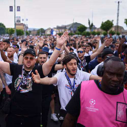 PSG supporters are accompanied by security ahead of the Champions League final soccer match between Paris Saint-Germain and Arsenal in Budapest, Hungary, Saturday, May 30, 2026. (AP Photo/Rudolf Karancsi-Albert)