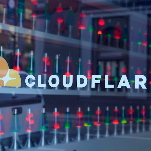 FILE - Lava lamps are seen through a lobby window at the headquarters of Cloudflare in San Francisco, Wednesday, Aug. 31, 2022. (AP Photo/Eric Risberg, File)