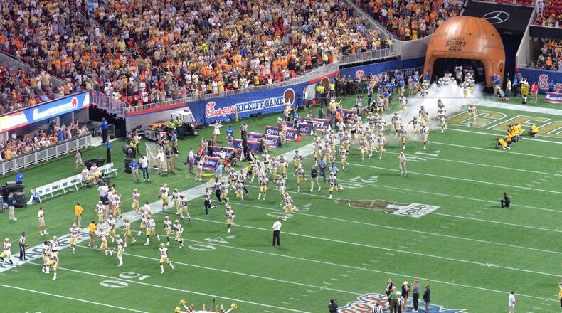 September 4, 2017 Atlanta - GA Tech's Ramblin Wreck and cheerleaders lead the football on the field before NCAA college football game against the Tennessee at the Mercedes-Benz Stadium on Monday, September 4, 2017. (HYOSUB SHIN / HSHIN@AJC.COM)
