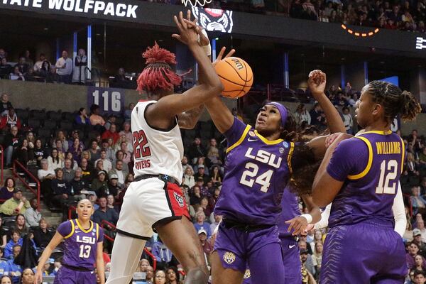North Carolina State guard Saniya Rivers (22) and LSU forward Aneesah Morrow (24) go after a rebound during the first half in the Sweet 16 of the NCAA college basketball tournament, Friday, March 28, 2025, in Spokane, Wash. (AP Photo/Young Kwak)