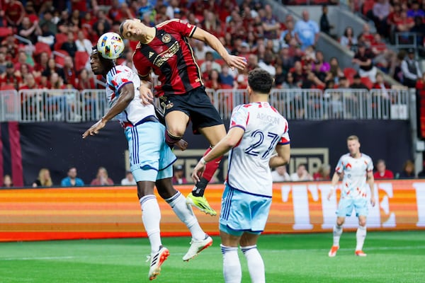 Atlanta United forward Giorgos Giakoumakis challenges Chicago Fire defender Carlos Terán for the ball during the first half of Atlanta United's 3-0 win Sunday at Mercedes-Benz Stadium. 
 Miguel Martinez/miguel.martinezjimenez@ajc.com