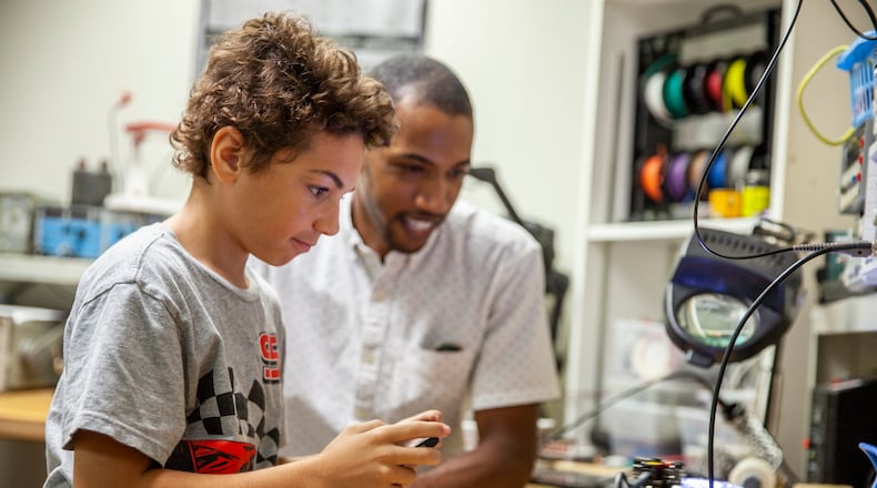 A student and his mentor test a robot at Big Brothers Big Sisters of Metro Atlanta, which received a grant through the Greater Atlanta COVID-19 Response and Recovery Fund for mentoring with a focus on both academic and social emotional support. Courtesy of The Community Foundation for Greater Atlanta