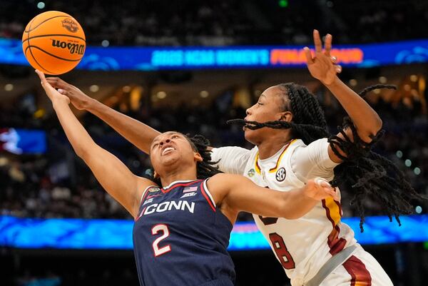 UConn guard KK Arnold (2) puts up a shot against South Carolina forward Joyce Edwards (8) during the second half of the national championship game at the Final Four of the women's NCAA college basketball tournament, Sunday, April 6, 2025, in Tampa, Fla. (AP Photo/John Raoux)