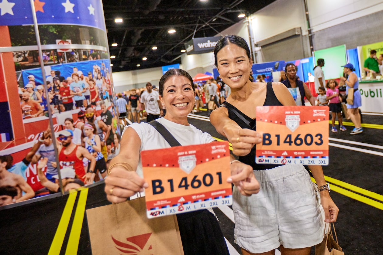 Runners pick up their bibs at the 2024 Peachtree Health and Fitness Expo at the Georgia World Congress Center in Atlanta. (Paul McPherson for Atlanta Track Club)