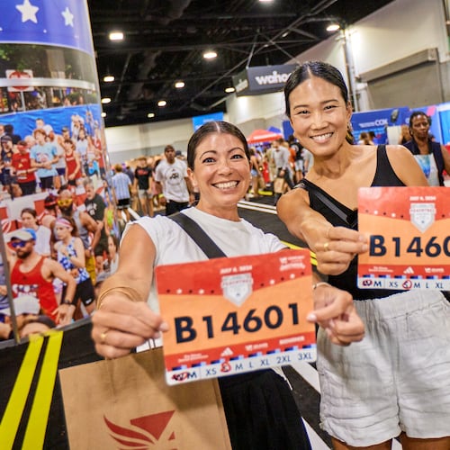Runners pick up their bibs at the 2024 Peachtree Health and Fitness Expo at the Georgia World Congress Center in Atlanta. (Paul McPherson for Atlanta Track Club)