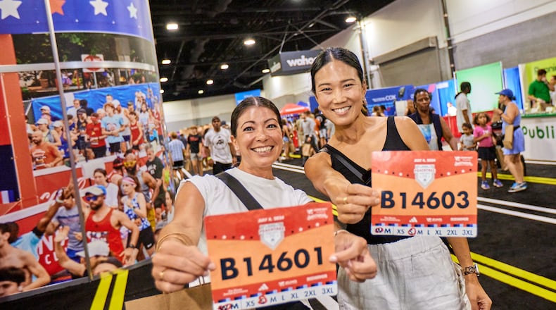Runners pick up their bibs at the 2024 Peachtree Health and Fitness Expo at the Georgia World Congress Center in Atlanta. (Paul McPherson for Atlanta Track Club)