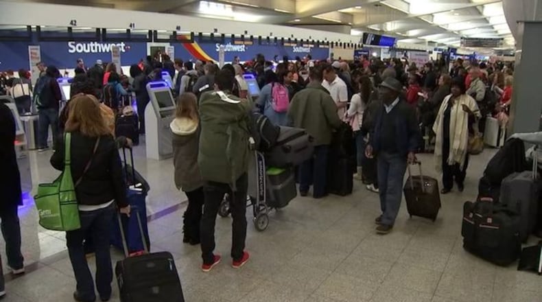 <p>Passengers waiting in line at Atlanta airport</p>