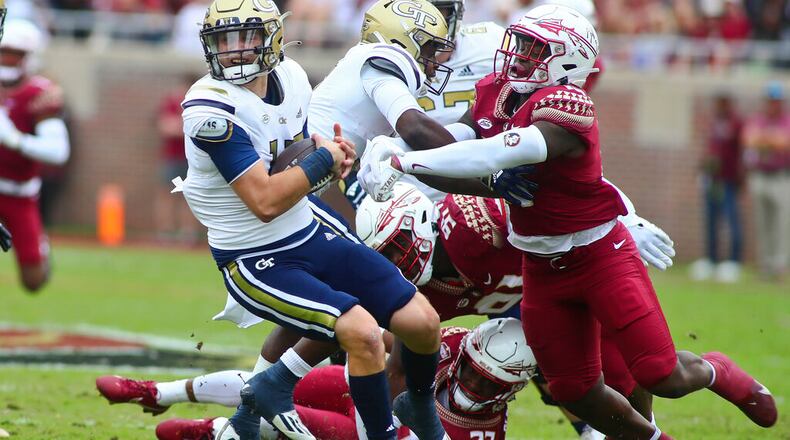 Florida State defensive back Akeem Dent (27) and linebacker Tatum Bethune combine to sack Georgia Tech quarterback Zach Pyron in the first quarter Saturday in Tallahassee, Fla. (AP Photo/Phil Sears)