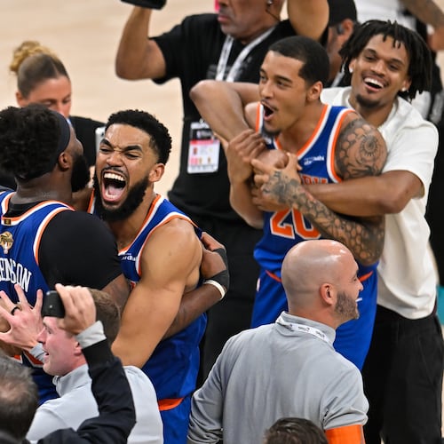 New York Knicks center Karl-Anthony Towns, right, hugs center Mitchell Robinson after defeating the San Antonio Spurs in Game 5 of the NBA Finals basketball series, Saturday, June 13, 2026, in San Antonio. (AP Photo/Darren Abate) CORRECTION: corrects ID to Mitchell Robinson instead Og Anunoby
