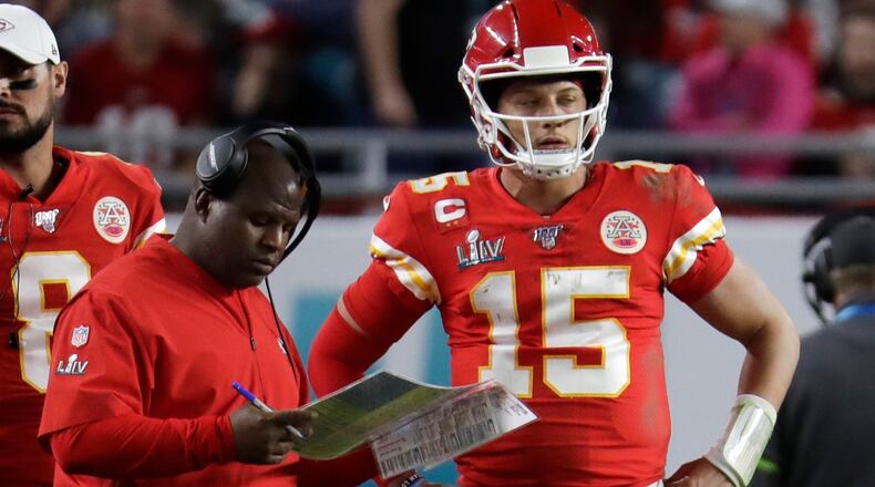 Offensive coordinator Eric Bieniemy speaks with Kansas City Chiefs quarterback Patrick Mahomes (15) during the second half of Super Bowl 54 against the San Francisco 49ers, Sunday, Feb. 2, 2020, in Miami Gardens, Fla. (Lynne Sladky/AP)