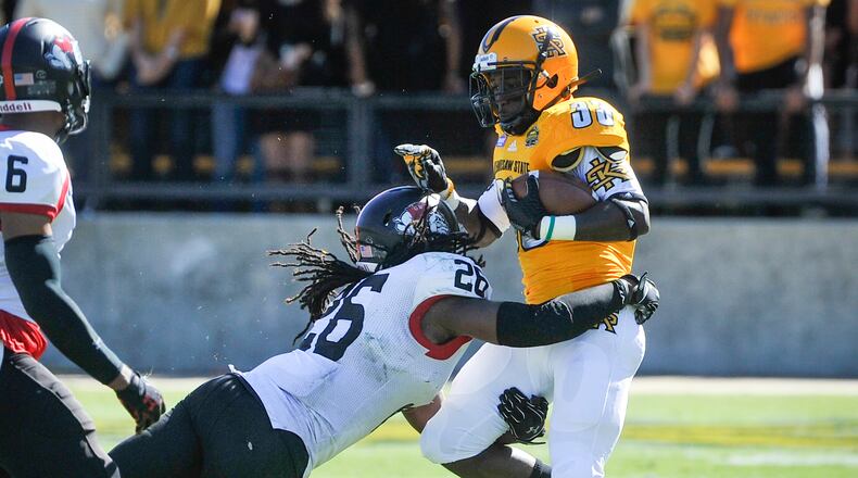 Kennesaw State running back Darnell Holland (33) is tackled by Gardner-Webb linebacker Aaron Cook (26) during the second half of an NCAA college football game, Saturday, Oct. 17, 2015, in Kennesaw, Ga. Holland rushed for 59 yards in the Owls’ 36-21 loss to Liberty on Saturday. (Photo/John Amis)