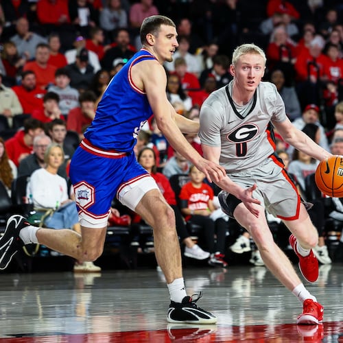 West Georgia guard Matija Žužic, left, defends against Georgia guard Blue Cain, center, during the second half of an NCAA college basketball game, Monday, Dec. 22, 2025, in Athens, Ga. (AP Photo/Colin Hubbard)