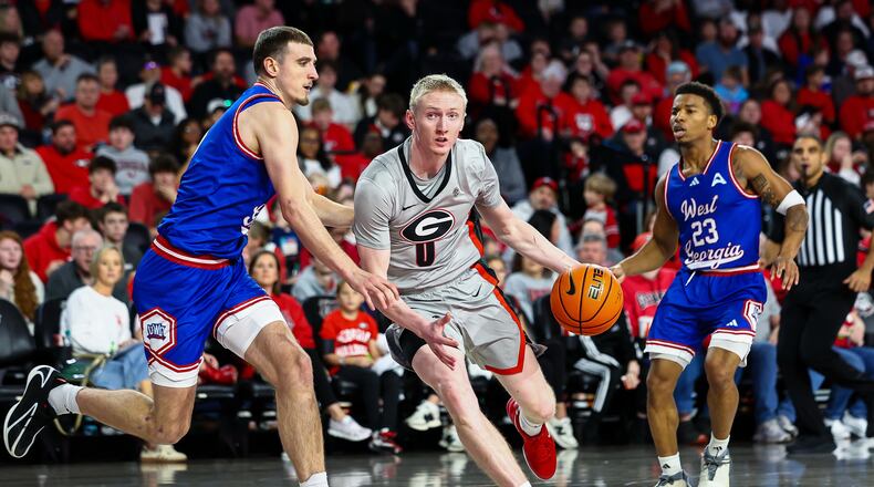 West Georgia guard Matija Žužic, left, defends against Georgia guard Blue Cain, center, during the second half of an NCAA college basketball game, Monday, Dec. 22, 2025, in Athens, Ga. (AP Photo/Colin Hubbard)