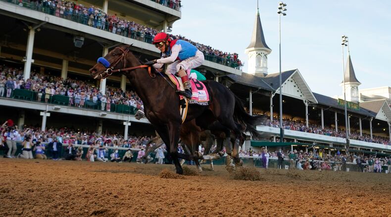 John Velazquez riding Medina Spirit crosses the finish line to win the 147th running of the Kentucky Derby at Churchill Downs, Saturday, May 1, 2021, in Louisville, Ky. (AP Photo/Jeff Roberson)