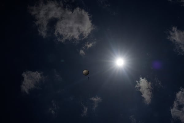 A weather balloon soars in the sky that was released by members of Project ICECHIP's black team to collect data Friday, June 6, 2025, in Morton, Texas. (AP Photo/Carolyn Kaster)