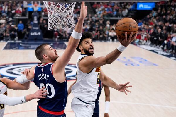 Denver Nuggets guard Jamal Murray, right, shoots as Los Angeles Clippers center Ivica Zubac defends during the first half in Game 4 of an NBA basketball first-round playoff series Saturday, April 26, 2025, in Inglewood, Calif. (AP Photo/Mark J. Terrill)