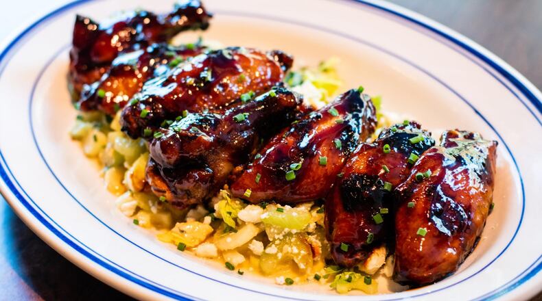 Though they’re listed on the menu as an appetizer, you could make a meal out of Coalition’s grilled chicken wings, which are served over a celery and blue cheese salad. CONTRIBUTED BY HENRI HOLLIS