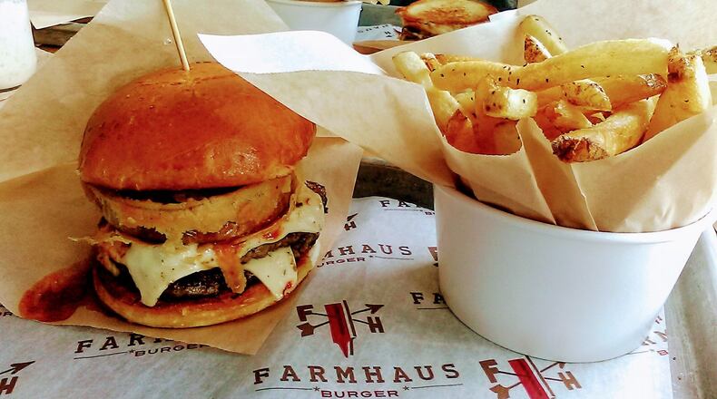 The Chili Cheese burger with a buttermilk battered onion ring on an artisan bun with a side of hand-cut Russet fries at Farmhaus Burger in downtown Augusta. CONTRIBUTED BY BLAKE GUTHRIE