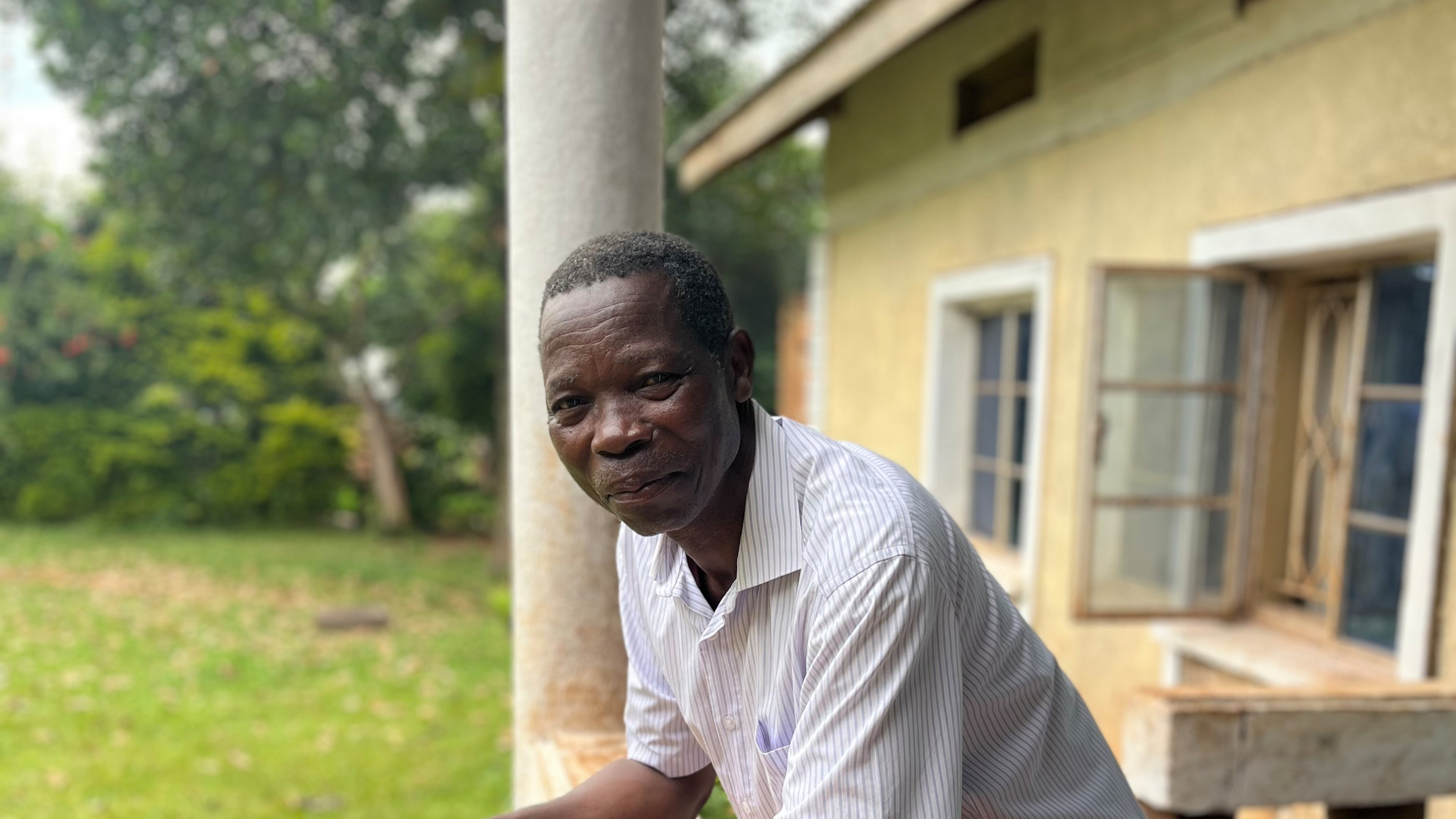 Moses Kutoi, a clan leader of the Bagisu people in eastern Uganda, stands on the balcony of his house in Nabumali, Mbale, Uganda, Wednesday, Nov. 19, 2025. (AP Photo/Rodney Muhumuza)