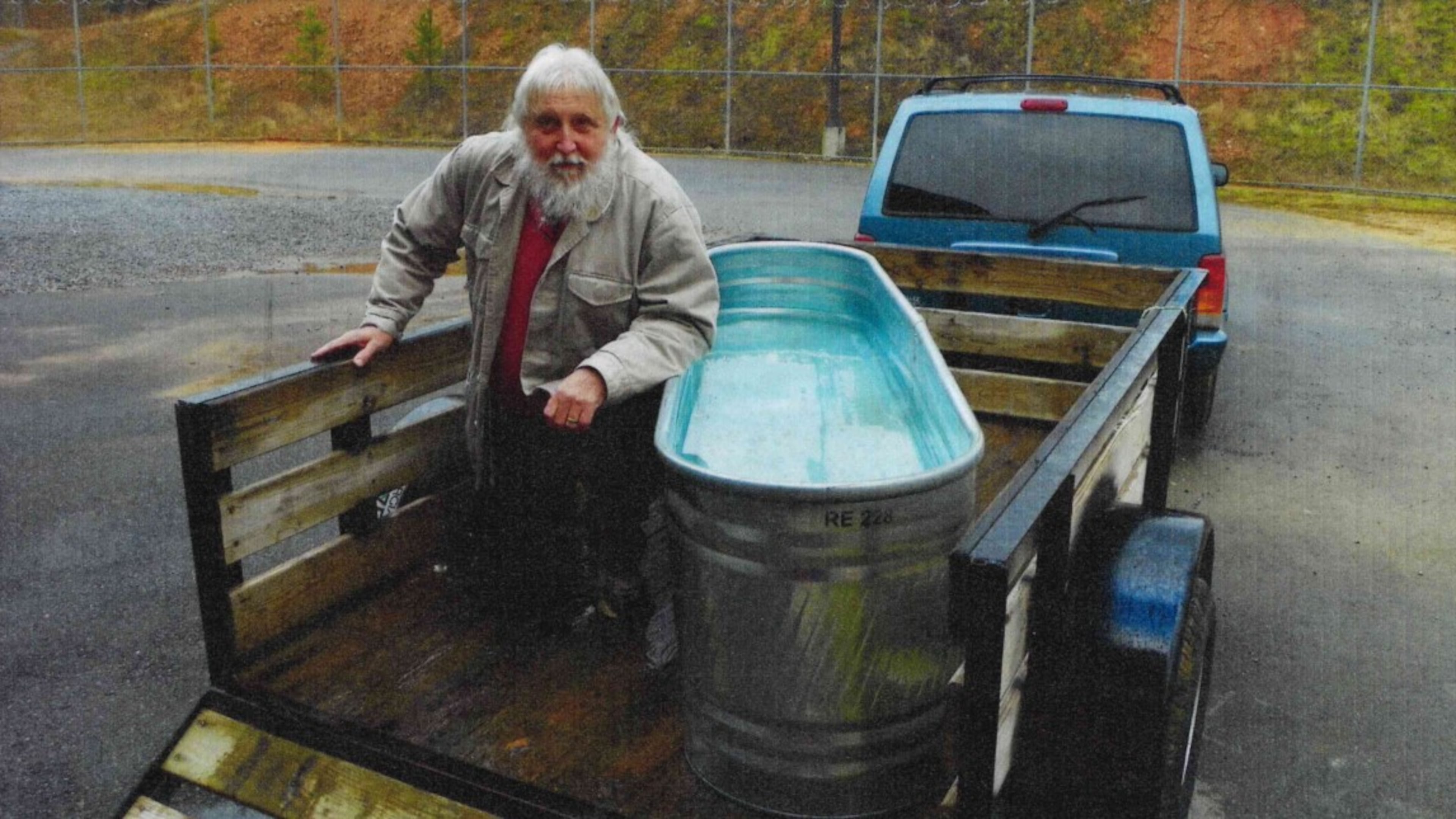 Evangelist Stephen Jarrard uses a horse trough to baptize jail inmates seeking salvation. He has settled his legal fight for inclusion in the Polk County Jail ministry program. (Courtesy photo)