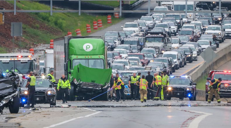Sandy Springs police and fire along with HERO units halted all southbound traffic on Ga. 400 on Tuesday after a multi-vehicle crash.  JOHN SPINK / JSPINK@AJC.COM