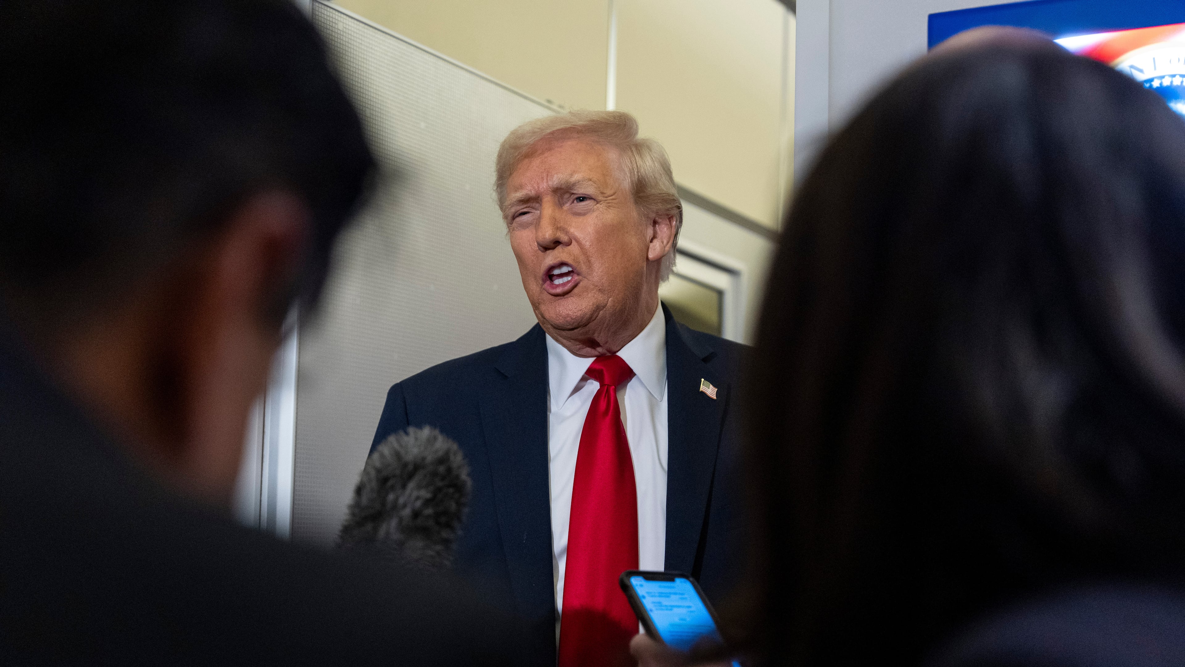 President Donald Trump speaks with reporters while in flight on Air Force One from Joint Base Andrews to his Mar-a-Lago estate in Palm Beach, Fla., Tuesday, Nov. 25, 2025. (AP Photo/Alex Brandon)