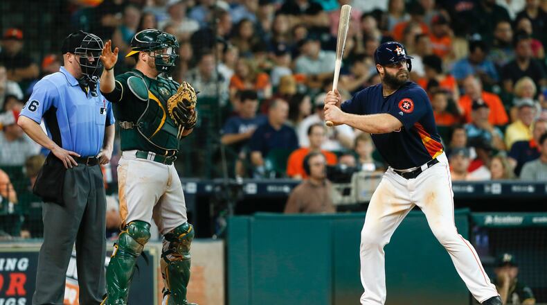 Evan Gattis #11 of the Houston Astros is walked intentionally in the seventh inning as Stephen Vogt #21 of the Oakland Athletics awaits the ball in front of home plate umpire Ryan Blackney at Minute Maid Park on June 5, 2016 in Houston, Texas. (Photo by Bob Levey/Getty Images)