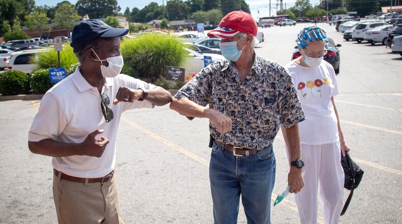 CEO Michael Thurmond talks with Kroger customers while handing out masks and No Mask, No Service signs to businesses on Wesley Chapel Rd in Decatur, Saturday 25, 2020.   STEVE SCHAEFER FOR THE ATLANTA JOURNAL-CONSTITUTION