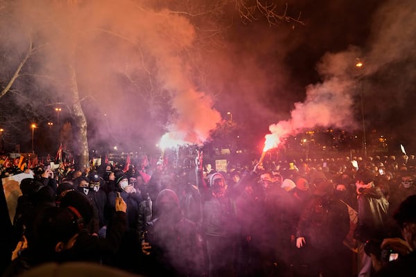People shout slogans next to anti riot police officers during a protest after Istanbul's Mayor Ekrem Imamoglu was arrested and jailed, in Istanbul, Turkey, Monday, March 24, 2025. (AP Photo/Khalil Hamra)