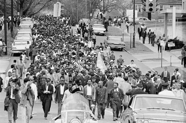 FILE - Demonstrators walk to the courthouse behind the Rev. Martin Luther King Jr. in Montgomery, Ala., March 17, 1965, to protest treatment of demonstrators by police during an attempted march. (AP Photo/File)