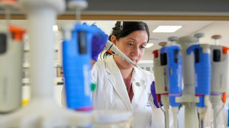 María Inés Barría, a virologist at the Universidad San Sebastián, works at the university, in Santiago, Chile, Wednesday, May 20, 2026. (AP Photo/Esteban Felix)