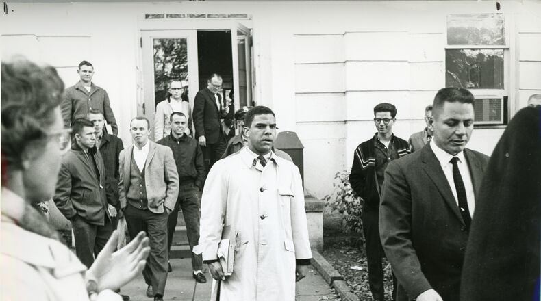 Surrounded by classmates and administrators, Hamilton Holmes Sr. begins classes at the University of Georgia in 1961. He was one of the first two black students.