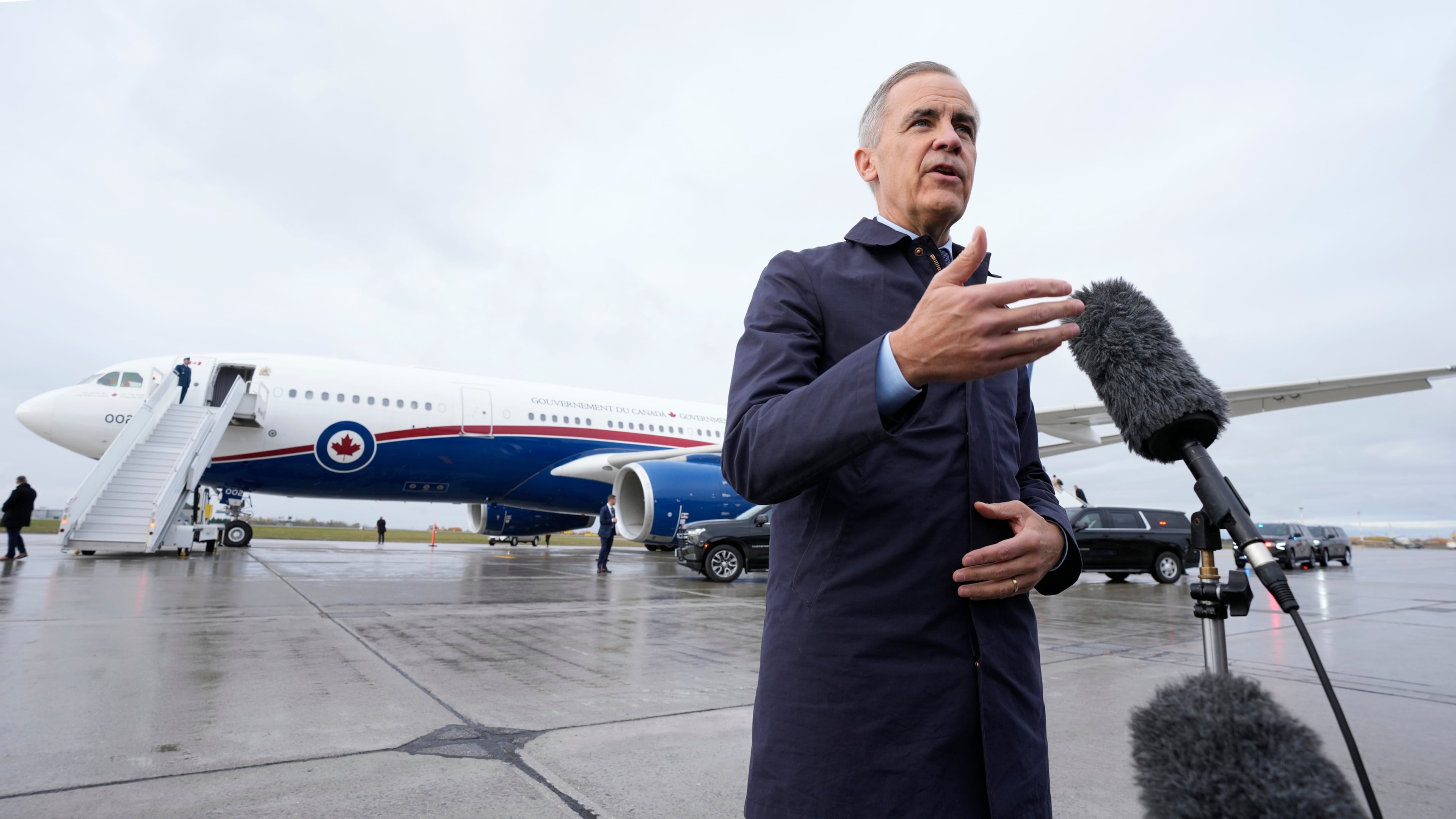 Canada Prime Minister Mark Carney speaks with members of the media before he boards a government plane in Ottawa on Friday Oct. 24, 2025. (Adrian Wyld/The Canadian Press via AP)