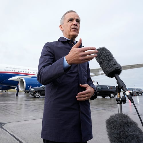 Canada Prime Minister Mark Carney speaks with members of the media before he boards a government plane in Ottawa on Friday Oct. 24, 2025. (Adrian Wyld/The Canadian Press via AP)