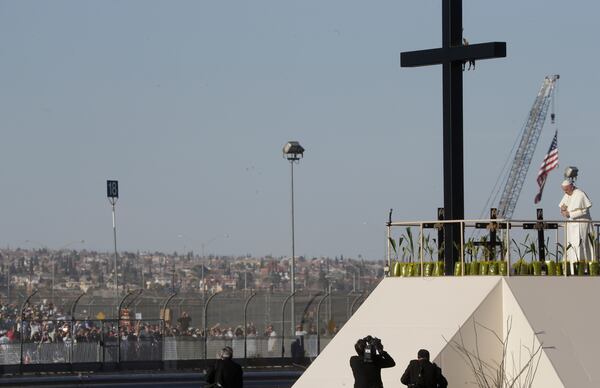 FILE— Hundreds of people gather on the U.S. side of the border to watch as Pope Francis prays at the U.S.-Mexico border fence along the Rio Grande, in Ciudad Juarez, Mexico, Feb. 17, 2016. (AP Photo/Gregorio Borgia, File)
